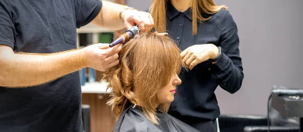 Dwóch Stylistów Zrobić Loki Fryzurę Długich Brązowych Włosów Lokówki Salonie — Zdjęcie stockowe