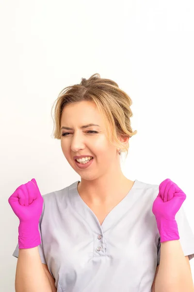 Happy Caucasian Woman Doctor Wearing Pink Gloves Celebrates Raising Fists — Stock fotografie