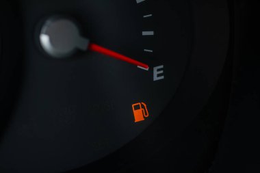 İğnenin yakın görüntüsü E 'nin boş bir yakıt deposu olduğunu gösteriyor. Yakıt göstergesi boş depo gösteriyor.