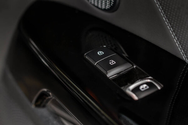 Car door lock switch close up. A car lock button. Car door handle with door lock control.