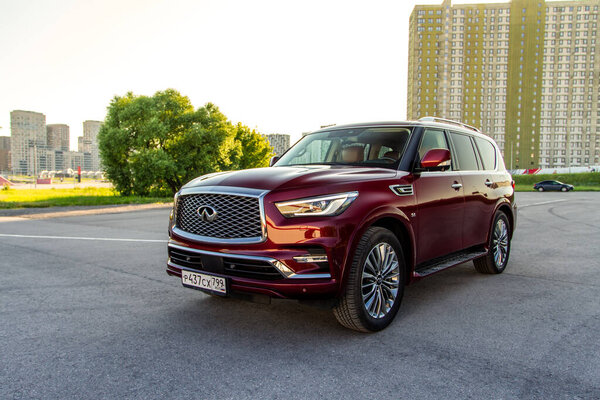 MOSCOW, RUSSIA - JUNE 20, 2021 Infiniti QX80 model year 2020 also called Infiniti QX5. A full-size luxury SUV. Exterior front side close up view on city background.