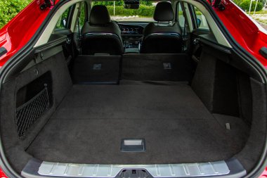 Minibüsün içinde kocaman, temiz ve boş bir araba bagajı var. Bagajı açık bir SUV 'nin arka görüntüsü.