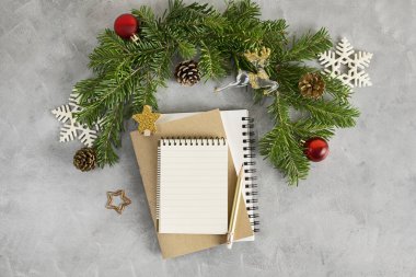 Top view dairesi, yılbaşı modelleri ve bir yığın defter ve kalemle yatıyordu. Dilek listesi, tatil konsepti. Metin uzayı