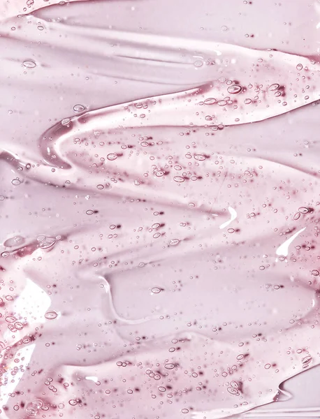 Pastel Pembe Arka Planda Hava Kabarcıkları Olan Şeffaf Kozmetik Serumu — Stok fotoğraf