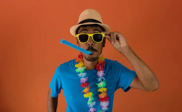 Black man in costume for brazil carnival isolated on orange background