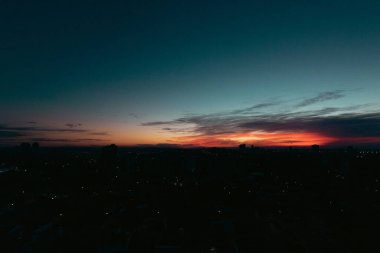 Şehrin siluetiyle yükselen güneş silueti silueti. 