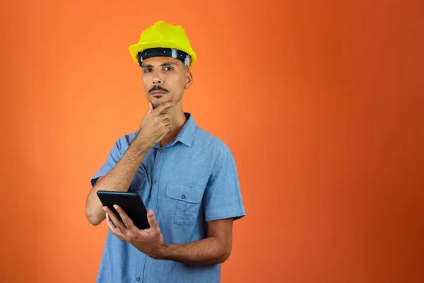Engineer Holding Mobile - Black Man in Safety Helmet and Blue Shirt isolated.