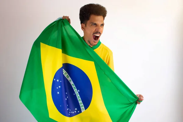 Brazilian Black Man Fan with Soccer Team Shirt Isolated on White. Sport Fan With Flag Celebrating the Cup.