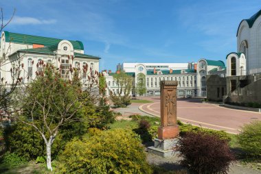 Kaliningrad, Russia - may 10, 2021: sculpture of cross and garden near Orthodox Gymnasium of the Kaliningrad Diocese of the Russian Orthodox Church