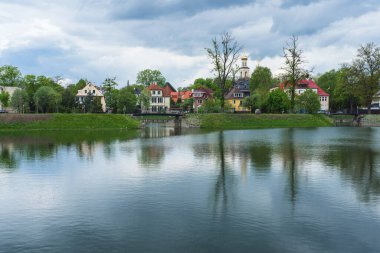 cityscape of Kaliningrad with small pond on gloomy spring day