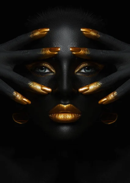 Beauty woman black skin color body art, gold makeup lips eyelids, fingertips nails in gold color paint. Professional gold makeup