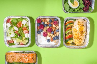 Sağlıklı yemek menüsü, kurye yemek teslimatı beslenme çantası. Biftek eti, tavuk fileto, balık ve sebzeler paketlerde. Günlük yemek diyet planı teslimatı, paket servisi, online sipariş konsepti.