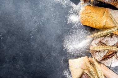 Çeşitli ekmek setleri. Birçok farklı buğday, tahıl ve çavdar ekmeği çavdar ve buğday, un ve fırıncı aletleriyle beyaz ahşap arka planda.