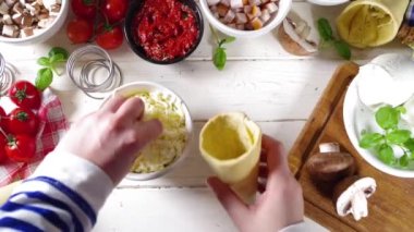 Cooking trendy Cone pizza background, modern pizza recipe, with tomatoes, basil, mozzarella cheese, baked pizza cones dough, ham and mushrooms