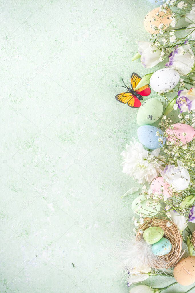 Happy Easter concept. Spring Easter holiday top view  flat lay background with easter eggs in nests and spring flowers. Easter greeting card background with copy space.