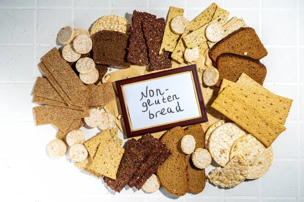 Gluten free allergic diet, celiac disease concept. Collection of various non-gluten different bread, whole grain loaves. Healthy alternative to bread, flatlay copy space