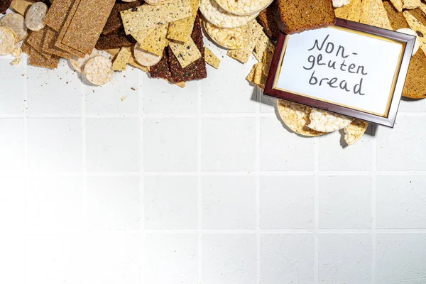 Gluten free allergic diet, celiac disease concept. Collection of various non-gluten different bread, whole grain loaves. Healthy alternative to bread, flatlay copy space