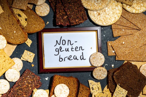 Gluten free allergic diet, celiac disease concept. Collection of various non-gluten different bread, whole grain loaves. Healthy alternative to bread, flatlay copy space