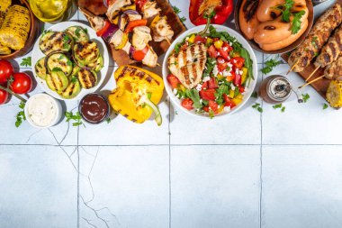 Izgara yaz bbq tabakları. Barda piknik pikniği çeşitli ızgara yiyeceklerle - şiş kebap şiş şiş, ızgara mısır, kızarmış tavuk salata, biftek, sosis, sebze