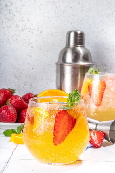 Homemade Summer Sparkling White Wine Sangria. Cold fizz fruit and berry infused alcohol drink, non-alcohol lemonade with fresh strawberry and orange, copy space