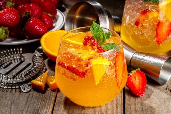 Homemade Summer Sparkling White Wine Sangria. Cold fizz fruit and berry infused alcohol drink, non-alcohol lemonade with fresh strawberry and orange, copy space