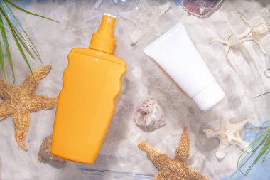 Sunscreen suncare background. Mockup background with vacation accessory, suntan lotion bottle, cosmetic cream, with seashells, straw woman's hat with sun glasses, top view copy space