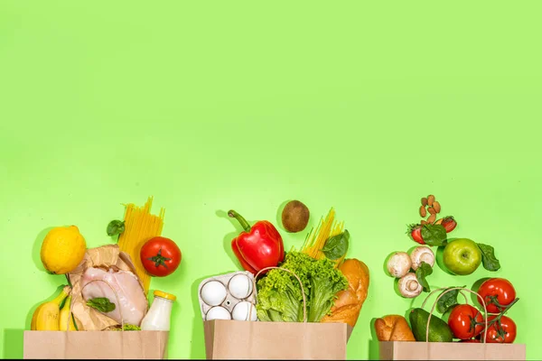 Fresh vegetables, meat, bread fruits in paper grocery bag. Delivery healthy food background. Healthy food cooking ingredients on white,background, Shopping food supermarket and clean vegan eating