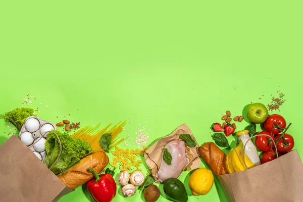 Fresh vegetables, meat, bread fruits in paper grocery bag. Delivery healthy food background. Healthy food cooking ingredients on white,background, Shopping food supermarket and clean vegan eating