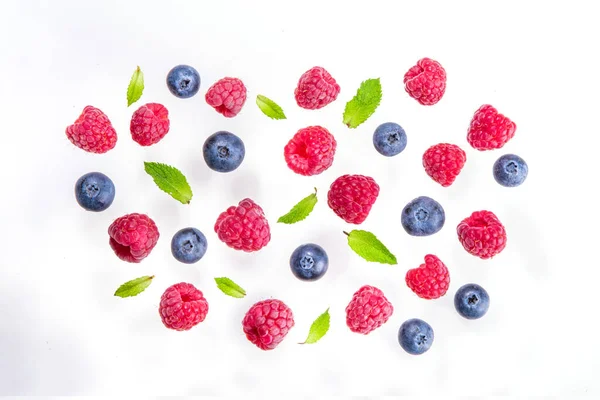 Fresh berries isolate on white background. Isolated raspberry, blueberry fruit macro shot on a white background