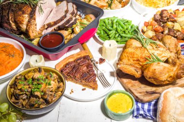Geleneksel Şükran Günü yemeğiyle birlikte Şükran Günü sofrası. Tavuk, patates püresi, taze fasulye, cevizli turta, fırında domuz eti, peynirli makarna, dolma, modern sert, güneşli, yassı bir ev.