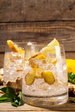 Refreshment Ginger Ale cocktail, Kombucha or Lemon Ginger iced lemonade drink. Sweet and sour alcohol drink copy space