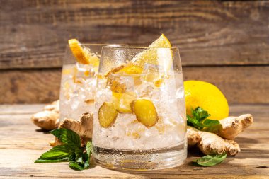 Refreshment Ginger Ale cocktail, Kombucha or Lemon Ginger iced lemonade drink. Sweet and sour alcohol drink copy space