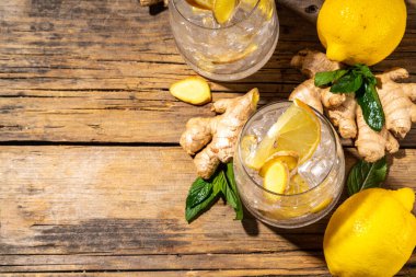 Refreshment Ginger Ale cocktail, Kombucha or Lemon Ginger iced lemonade drink. Sweet and sour alcohol drink copy space