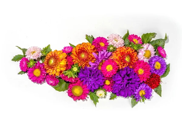 Autumn flowers flatlay background. Bouquet of colorful chrysanthemum, peonies  (orange, purple, yellow, red) flowers on white background, frame border for greeting card top view copy space for text