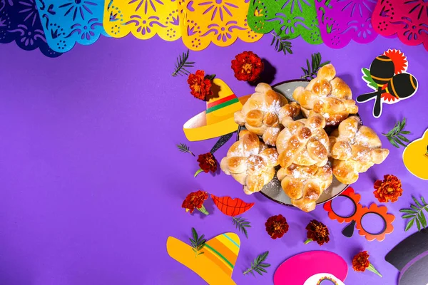 Spanish Mexican traditional holiday, autumn festival Day of the Dead (dia de los muertos) background. With traditional Pan de Muerto bread, decorations and marigold and cempasuchil flowers