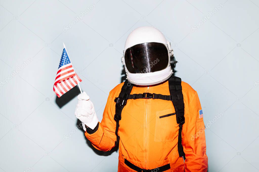 Man with astronaut helmet showing United States flag
