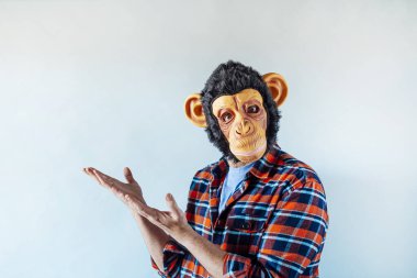 Maymun maskeli adam el kol hareketi yapıyor..