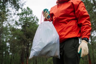 Ormanda çöp ve plastik toplayan adam..