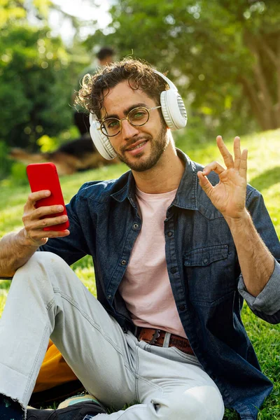 Outdoor Portrait Handsome Young Hipster Man Listening Music Headphones Mobile —  Fotos de Stock