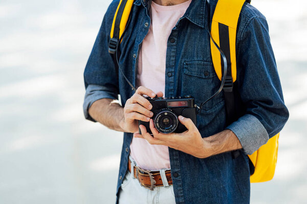 Young man taking photos in Madrid with an analog camera.