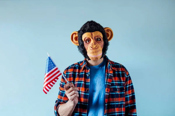 Man with a monkey mask and a flag of the United States of America.