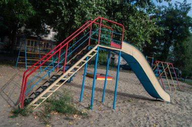 Metal children's slide in the park on a sunny day