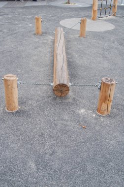 A wooden log for playing children to keep balance.