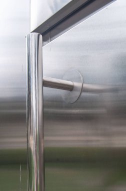 Fragment of a closed metal door outdoors.