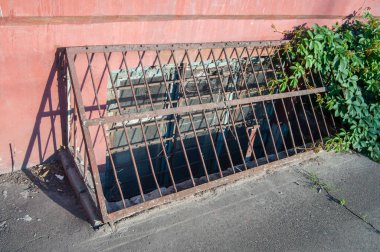 Protective metal grille for windows on the basement floor of a manufacturing enterprise