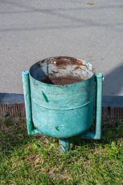 Parktaki eski metal paslı çöp tenekesi.