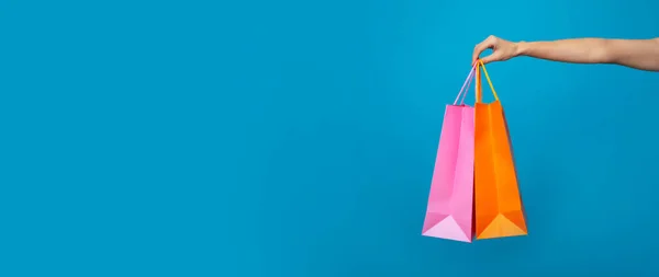 Banner Photo Female Hand Shopping Bags Isolated Blue Background Royalty Free Stock Images