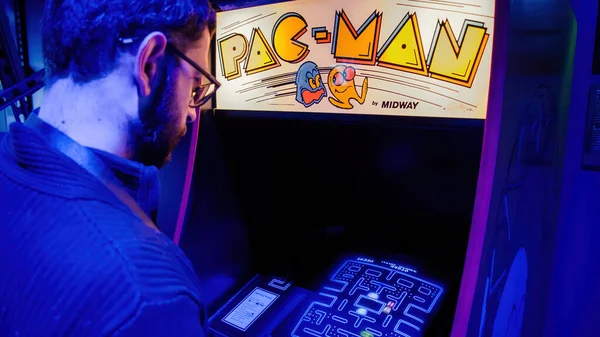 İstanbul, Türkiye - Şubat 2016: Pac-man oyun konsolu makine dolabıyla oynayan adam