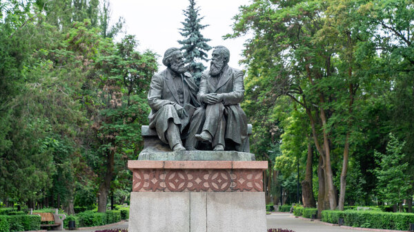 Bishkek, Kyrgyzstan - May 2022: Monument from Soviet era, statues of Karl Marx and Friedrich Engels