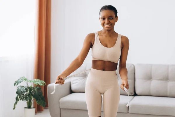 Young Black Woman Measures Her Waist Living Room Background Concept — Stock Photo, Image